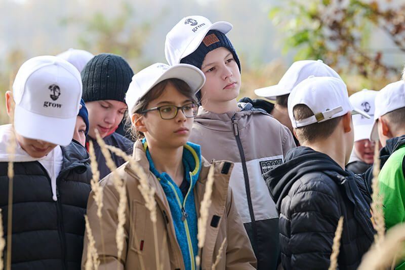 Children in GROW caps at a planting